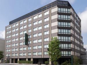 an office building with a sign in front of it at Loisir Hotel Kyoto Toji in Kyoto