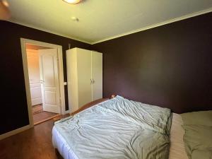 a bedroom with a bed and an open door at Holiday home SURAHAMMAR in Surahammar