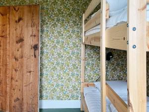 a room with two bunk beds and a window at Holiday home Björklinge in Björklinge