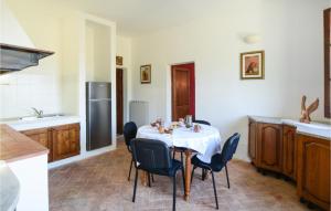 a kitchen with a table with chairs and a refrigerator at 4 Bedroom Lovely Home In Santa Luce in Santa Luce