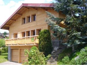 ein Holzhaus mit einer Treppe, die hinauf führt in der Unterkunft Chalet au calme avec sauna, proche des pistes, parking - FR-1-598-123 in Les Gets