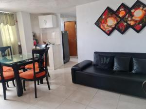 a living room with a black couch and a table at EDIFICIO MENDEZ in Cartagena de Indias