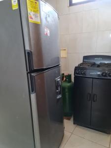 a refrigerator in a kitchen next to a stove at EDIFICIO MENDEZ in Cartagena de Indias