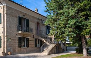 an old brick building with stairs and a tree at Cozy Apartment In Miglianico With Wifi in Miglianico