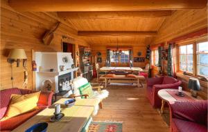 a living room with couches and a fireplace in a cabin at Beautiful Home In Sjusjen With 3 Bedrooms in Sjusjøen