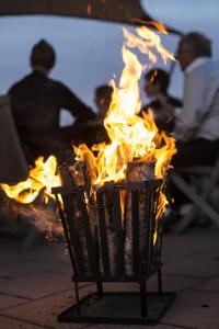 a fire in a trash can with flames in it at Hotell Klockargården in Tällberg