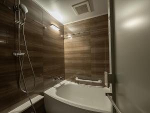 a bathroom with a shower with a toilet and a sink at Loisir Hotel Kyoto Toji in Kyoto