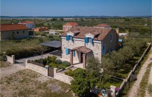 an aerial view of a stone house with blue windows at Villa Stella Del Lago in Vrana