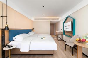 Letto o letti in una camera di Guangzhou Yilin Hotel - Xiaogang metro Store