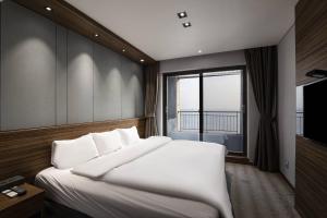 Postel nebo postele na pokoji v ubytování Western Grace Hotel Incheon