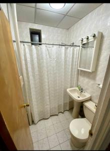 a bathroom with a toilet and a sink at Woodside, queens in Woodside