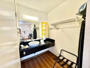 a bathroom with a sink and a mirror at Studio 6 Bellflower CA Los Angeles in Bellflower