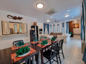 a dining room and living room with a table and chairs at Baan Gecko in Ao Nang Beach