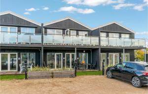 a house with a car parked in front of it at 2 Bedroom Amazing Apartment In Slagelse in Slagelse