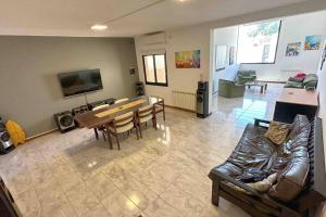 a living room with a table and a couch at Casa Familiar Premium in San Fernando del Valle de Catamarca