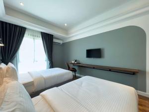 Postel nebo postele na pokoji v ubytování Hotel Seri Costa