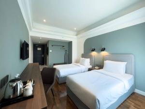 Postel nebo postele na pokoji v ubytování Hotel Seri Costa