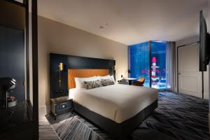 a hotel room with a bed and a window at Dorsett Melbourne in Melbourne