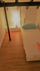 a bedroom with a bed and a wooden floor at Superior Motel l in Haifa