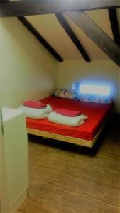 a bedroom with a bed with two pillows on it at Superior Motel l in Haifa +11 photos