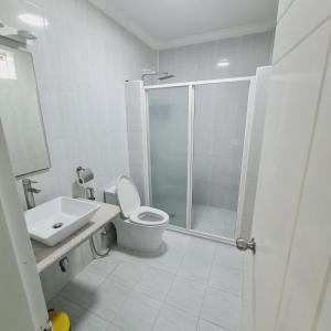 a bathroom with a shower and a toilet and a sink at Aanirustayinn in Hoarafushi