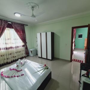 a bedroom with a bed with flowers on it at Aanirustayinn in Hoarafushi