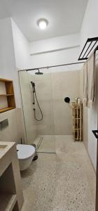 een badkamer met een douche, een toilet en een wastafel bij 108 sea views in Ukunda