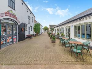 a cobblestone street with tables and chairs in front of buildings at Robin - Uk45516 in Humberstone