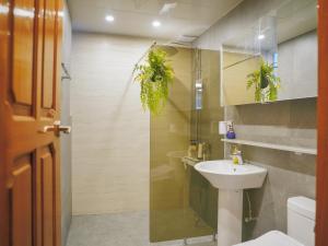 a bathroom with a sink and a shower with plants at Seogwipo Classic in Seogwipo