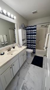 a bathroom with a sink and a toilet and a mirror at Waterview Townhouse 4-Bedrooms in Corpus Christi +14 photos