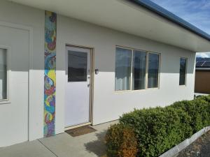 a white house with a colorful mosaic on the door at True Blue Five - The Residence in Sheffield