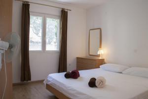 a bedroom with two beds with hats and a mirror at House Baglija in Lumbarda