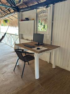 a desk with a computer sitting on top of it at Punta Arena EcoHostal and EcoFit An Eco-Friendly Oasis for Adventurous Explorers and Serenity Seekers01 in Cartagena de Indias