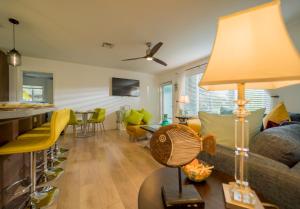 a living room with a couch and a table with a lamp at Deerfield Beach Boca Raton with pool 1 mile from the beach in Deerfield Beach