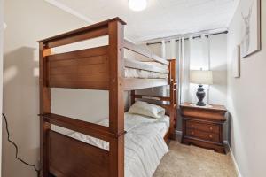 a bedroom with two bunk beds and a desk at Charming Glenolden Townhouse in Glenolden