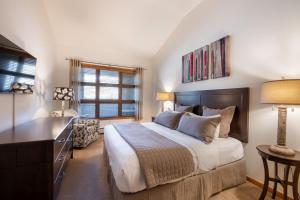 1 dormitorio con 1 cama, vestidor y escritorio en Zephyr Mountain Lodge - Premium Rated Condo 1701, en Winter Park