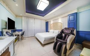 a hotel room with a bed and a desk at Olle Business Hotel in Gwangju