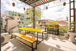 a patio with tables and chairs on a balcony at Leila House - 3BRs - Central Danang in Da Nang
