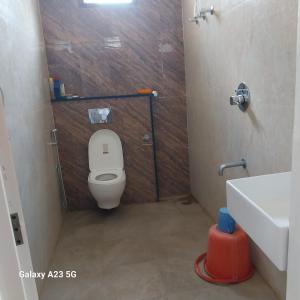 a small bathroom with a toilet and a sink at 1 Bedroom & Living Room for Friends & Families in Chāmundi