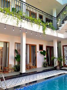 a house with a swimming pool and a patio at Hang Mua Boutique in Ninh Binh
