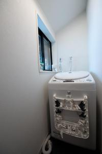 a washing machine in a bathroom with a sink at Izumo Biyori - Vacation STAY 66967v in Izumo