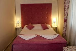 a bedroom with a large bed with two pillows at Dalyan Terrace Hotel in Dalyan +11 photos