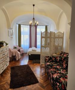 a living room with a bed and a couch at Christa Central 1 in Sibiu
