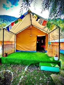 a large tent with green grass in front of it at The Posh Camps in Pahalgām
