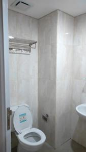 bagno con servizi igienici e lavandino di Apartemen Skylounge Makassar a Manda