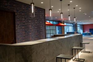 a lobby with a bar with stools at KAMENOI HOTEL Kusatsu Yubatake in Kusatsu