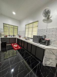 a kitchen with a counter with a microwave on it at Rania Riverview Guesthouse in Kuala Berang