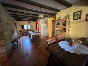 a living room with a table and a dining room at Villa El Molino Blanco in Molinos de Razón