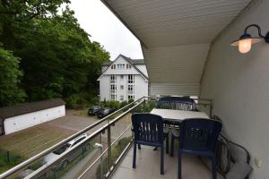 a balcony with two chairs and a table on a balcony at Ferienwohnung-6-15 in Baabe