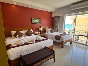 Ein Bett oder Betten in einem Zimmer der Unterkunft Aristocrat Residence & Hotel
